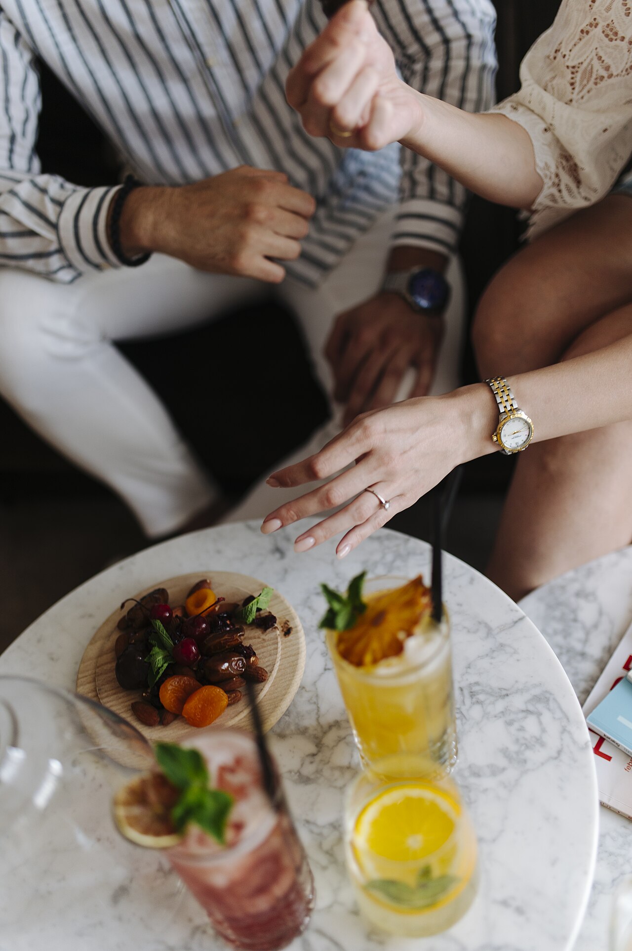Friends enjoy drinks and snacks at a table jpg (Newcomer Dinners: Cap at Six People)